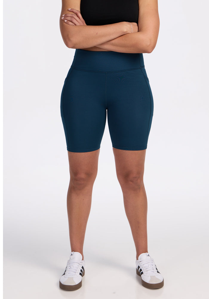 Bike shorts with visible side-pocket area on a plain background