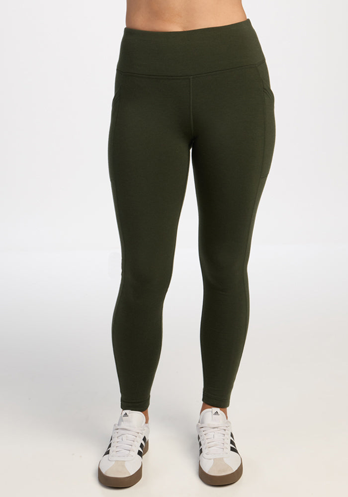Person in Woolx Frost Leggings - Duffel Bag and white sneakers, standing against a plain white background. | Ariana is 5'11", wearing a size S