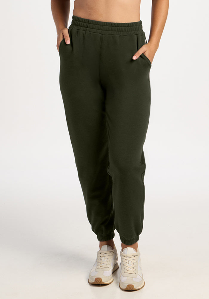 Model in Woolx Parker Sweatpants - Duffel Bag, hands in pockets, paired with white sneakers on a light background. 