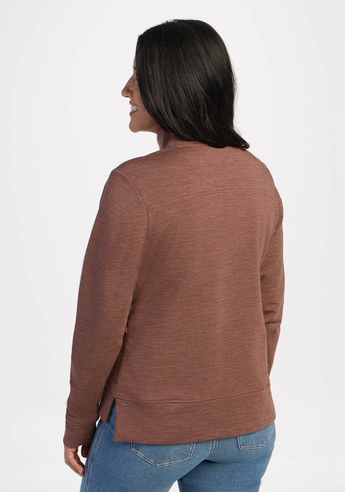 Woman in Woolx Annie 3 Button Pullover - Sable Heather and blue jeans, facing away with a subtle smile.