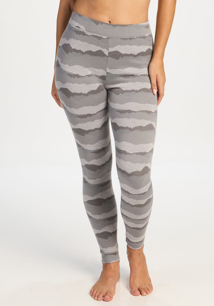 A person models Woolx Taylor Baselayer Leggings - High Peaks, barefoot against a plain white background. 