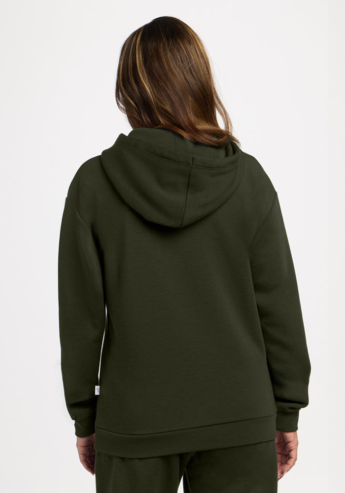 Model wears Woolx Avery Hoodie - Duffel Bag and matching pants, shown from the back on a plain, light background.
