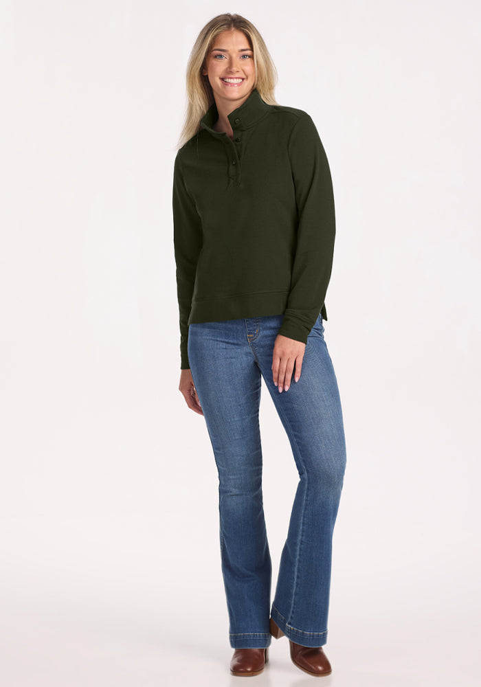 Woman in Woolx Annie 3 Button Pullover - Duffel Bag, blue jeans, brown boots, smiling against a white background.