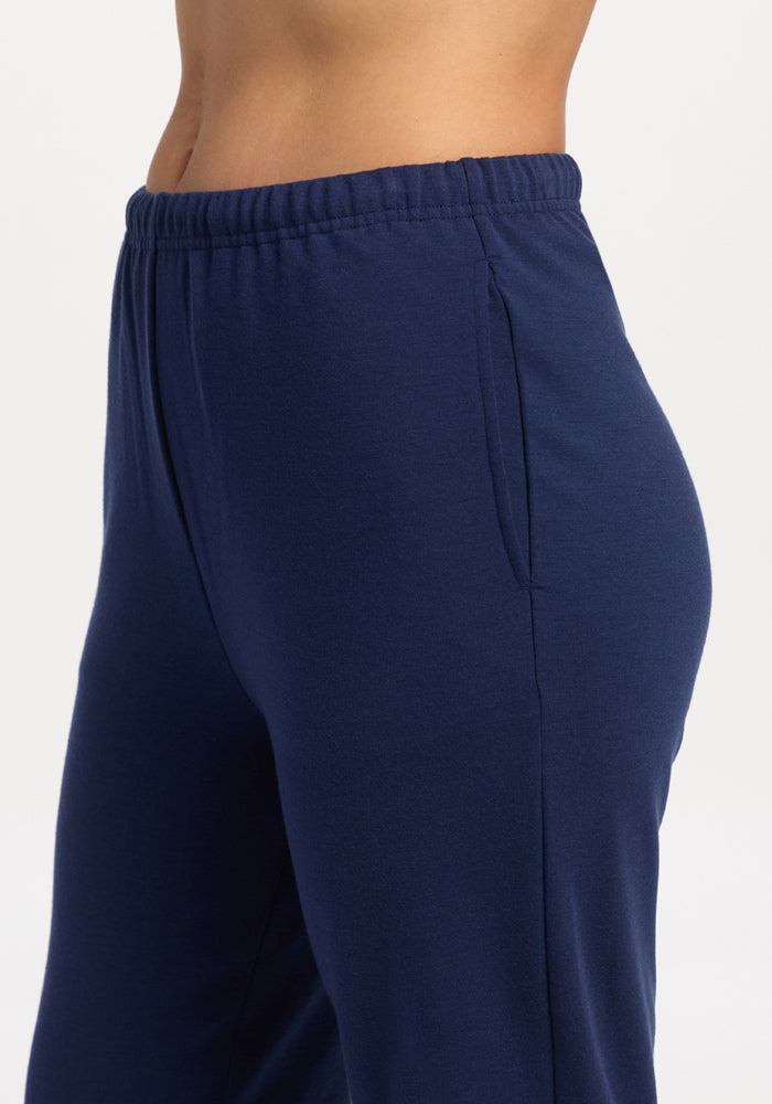 Person in Woolx Juliette Joggers - Ocean Cavern, moisture wicking, elastic waist, side pocket, shown from the side.