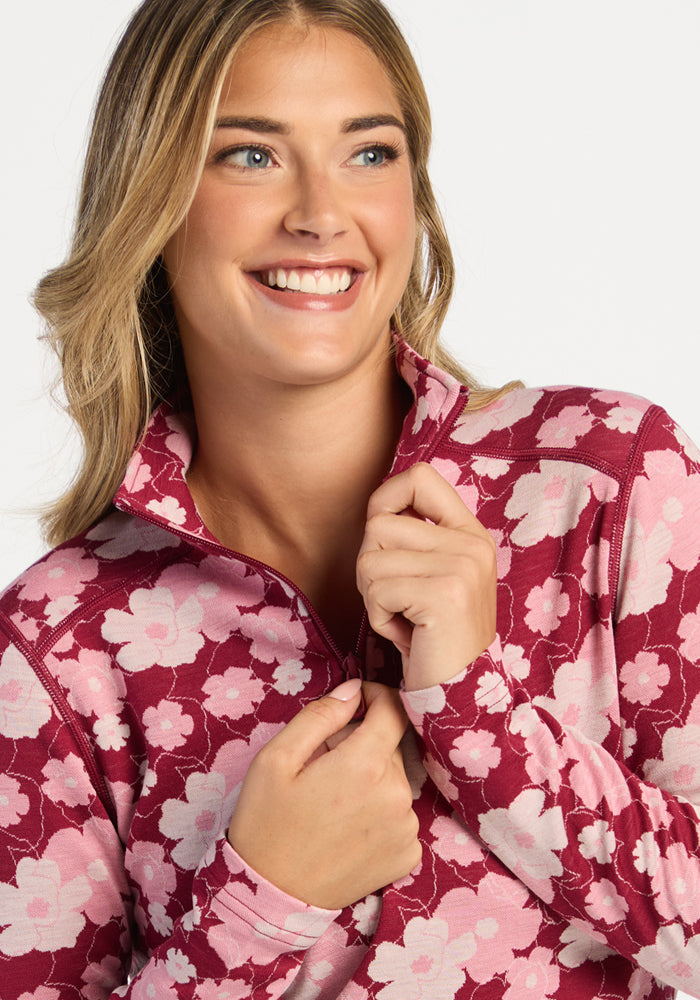 Woman in the Woolx Emi 1/4 Zip - Floral Crush over a Merino base layer, looking off to the side.