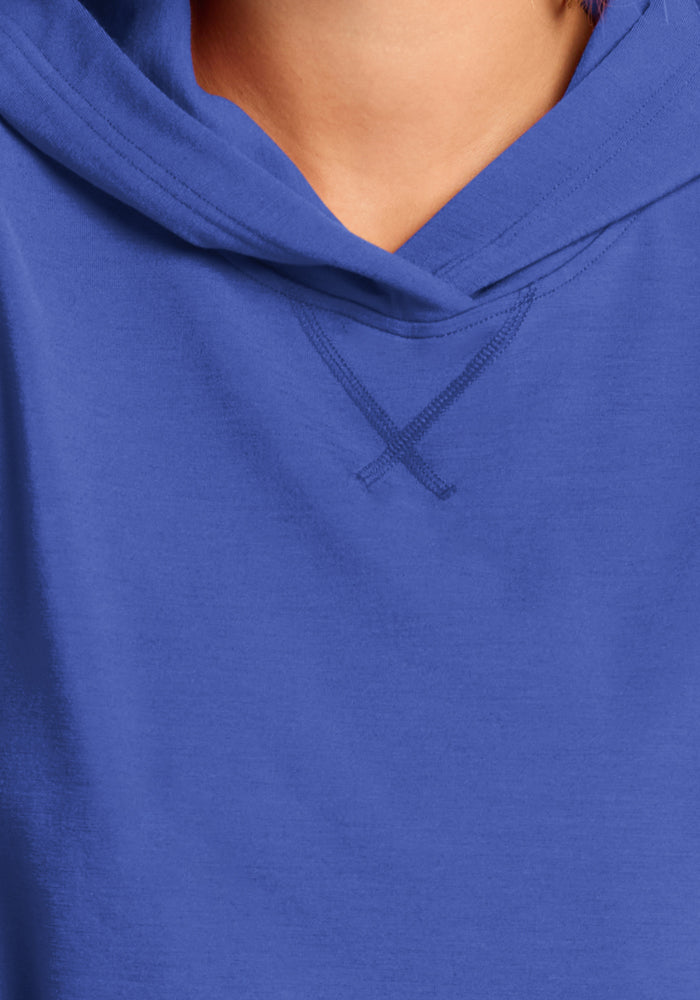 Close-up of a person in a Woolx Lizzy Hoodie - Royal Blue, highlighting the neckline and part of the hood.