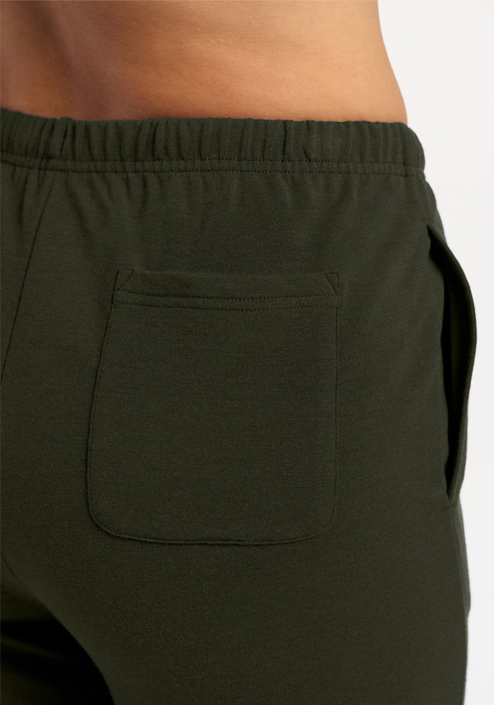 Close-up of a person wearing Woolx Juliette Joggers - Duffel Bag, featuring elastic waistband and pockets.