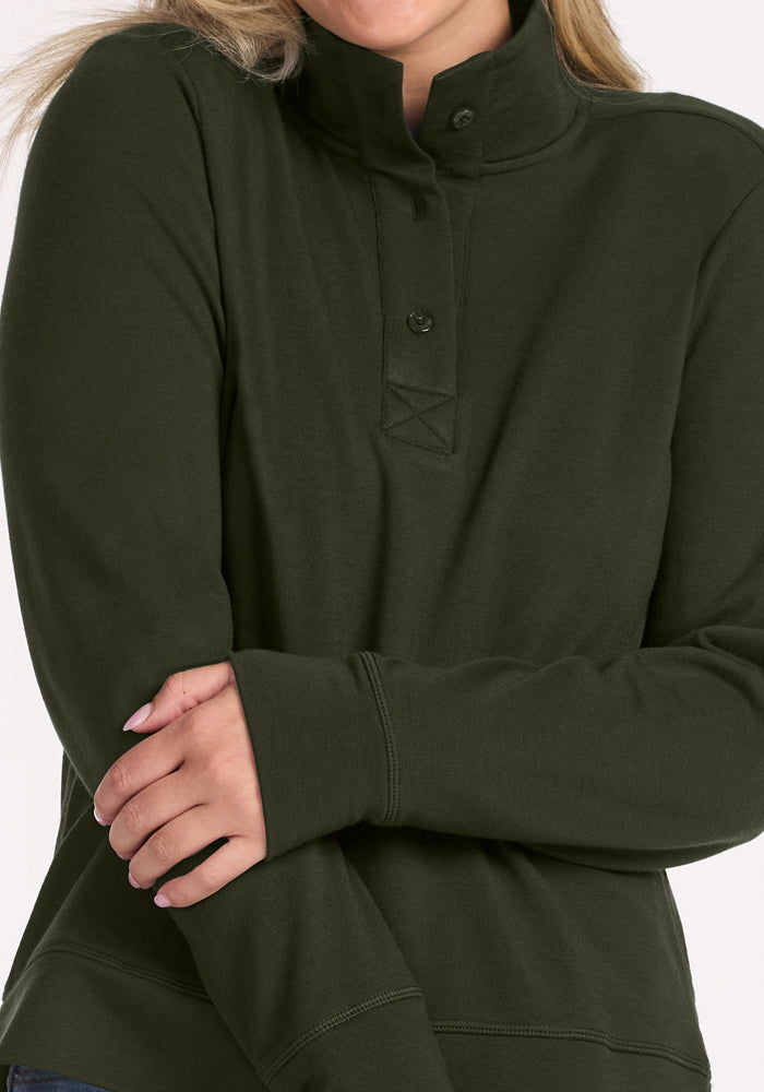 Model in Woolx Annie 3 Button Pullover - Duffel Bag, arms crossed and face partly hidden.