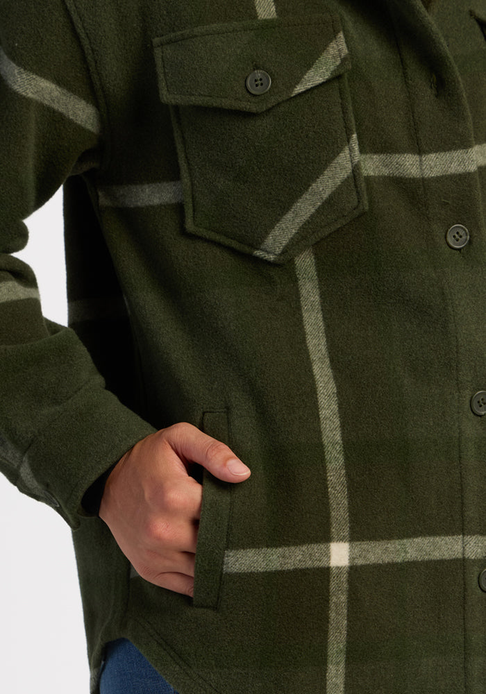 She wears the Woolx Sawyer Shacket in Driftwood Fern Plaid—one hand in pocket, one by her side.