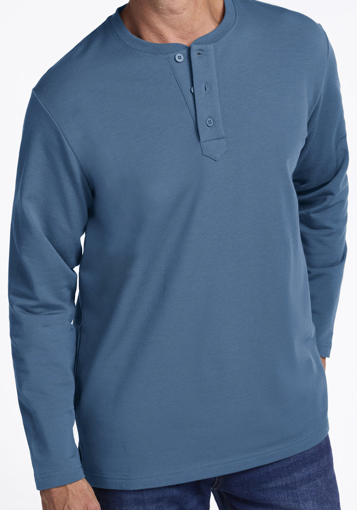 Man in Woolx Jackson Henley - Blue Ashes and jeans, shown mid-chest to thigh, on white background.