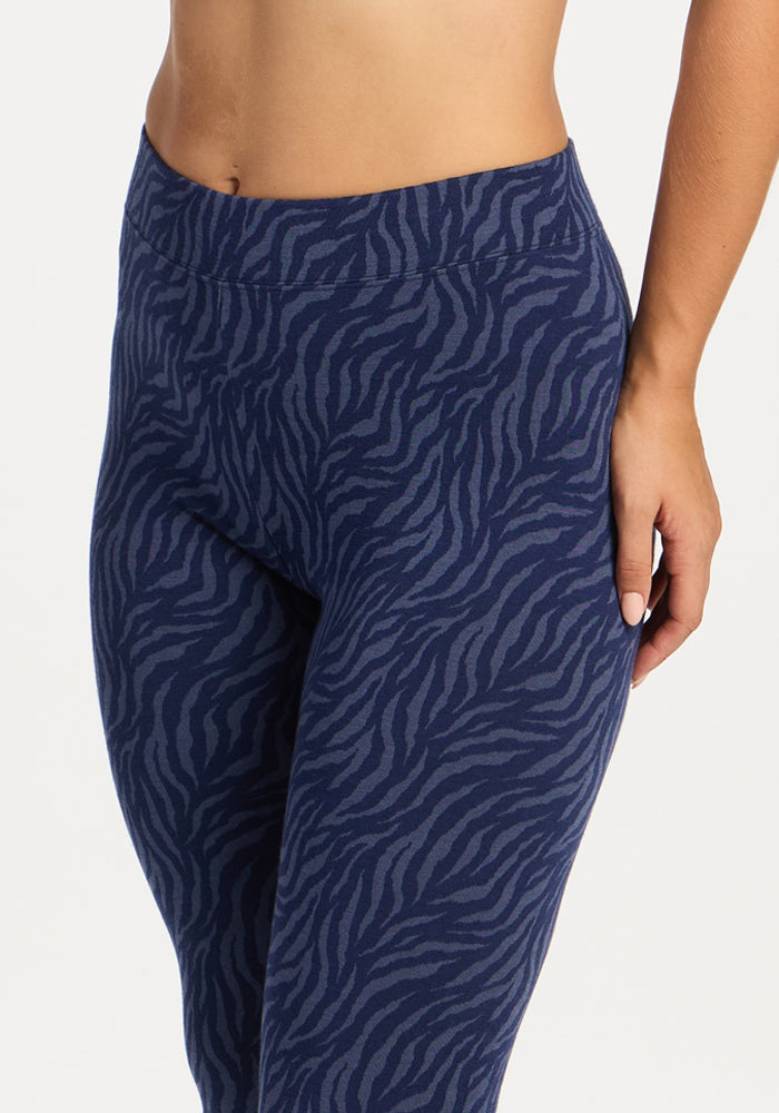 Person wearing Woolx Taylor Baselayer Leggings - Midnight Safari, hand by their side.