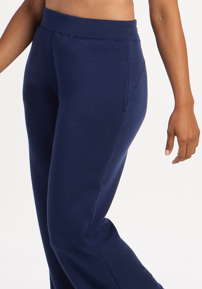Model in Woolx Bree Lounge Pants - Ocean Cavern, side view highlights waistband; one arm relaxed at their side.