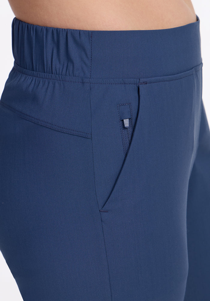 Close-up of a person wearing Woolx Nicole Crop Pants in Vintage Indigo, featuring an elastic waistband and side pocket, shown from waist to mid-thigh against a white background.