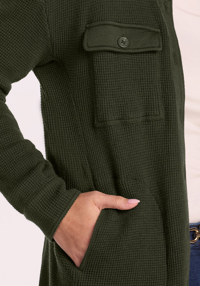 A person in the Woolx Oaklynn Waffle Shacket - Duffel Bag, with chest & side pockets—ideal for warm layering.