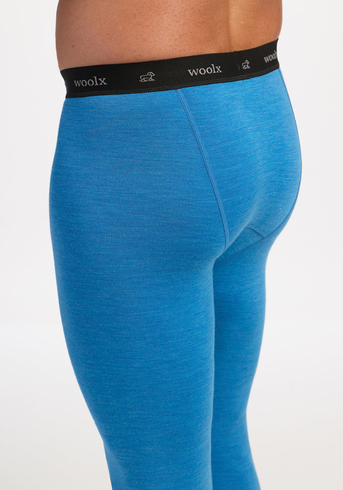 Person in blue Backcountry Leggings - Blue Razz by Woolx, shown from side and back, with black “woolx” waistband.