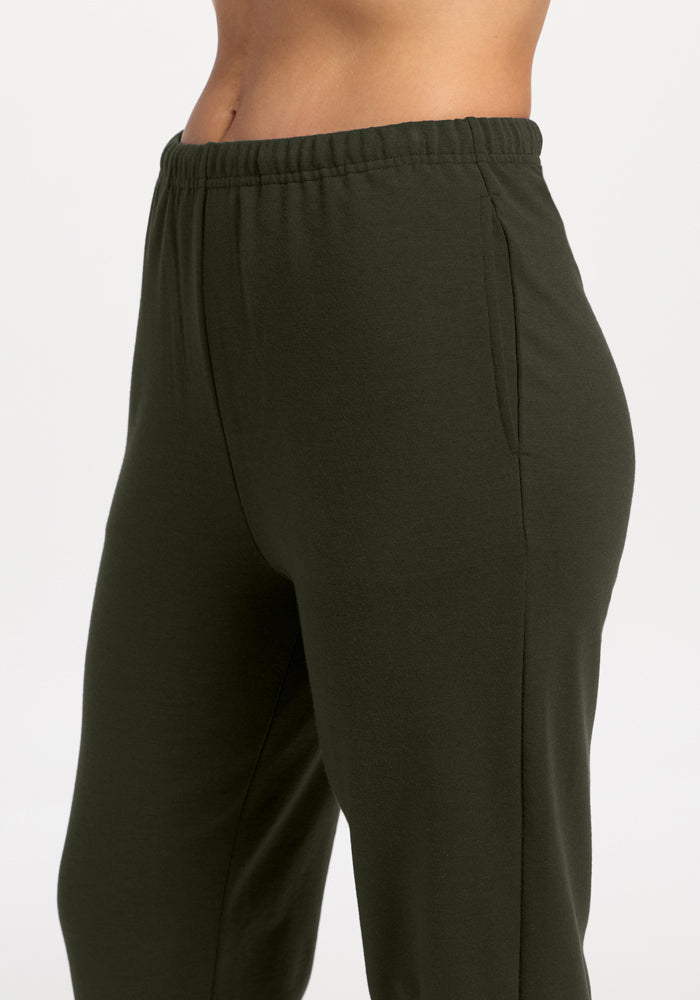 Model wears Woolx Juliette Joggers in Duffel Bag, relaxed fit with elastic waistband and side pockets, waist down.