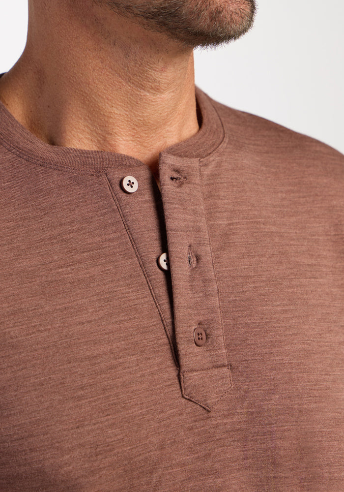 Close-up of a person in the Woolx Jackson Henley - Sable Heather, showing three buttons, neck, and jawline.