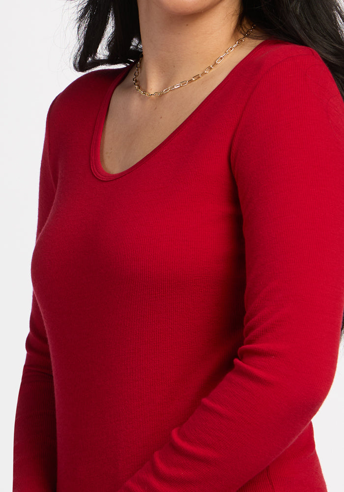 Woman in the Woolx Katie Ribbed Long Sleeve - Maraschino Cherry, gold chain necklace, shown shoulders to waist.