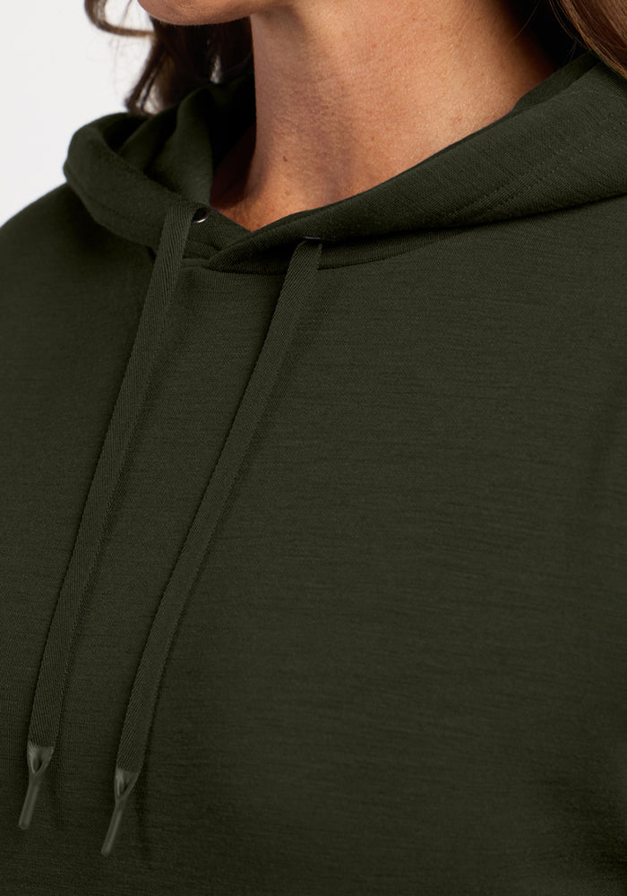 Close-up of a person in a Woolx Avery Hoodie - Duffel Bag, highlighting the cozy drawstrings and neckline details.