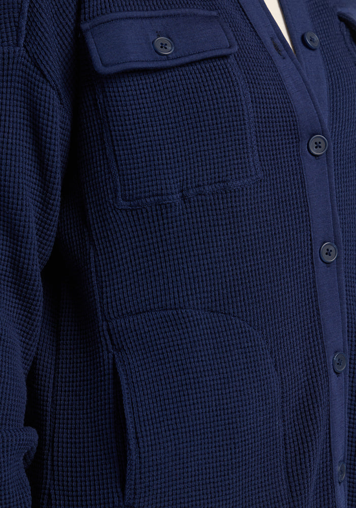 Close-up of the Woolx Oaklynn Waffle Shacket in Ocean Cavern, featuring two pockets and button front.