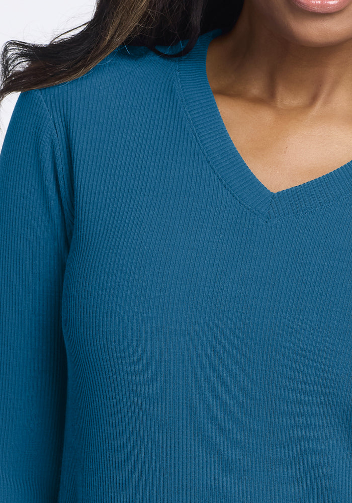Woman wears Woolx Evie Ribbed Tunic in Blue Pine, shown from chest to just below the chin.