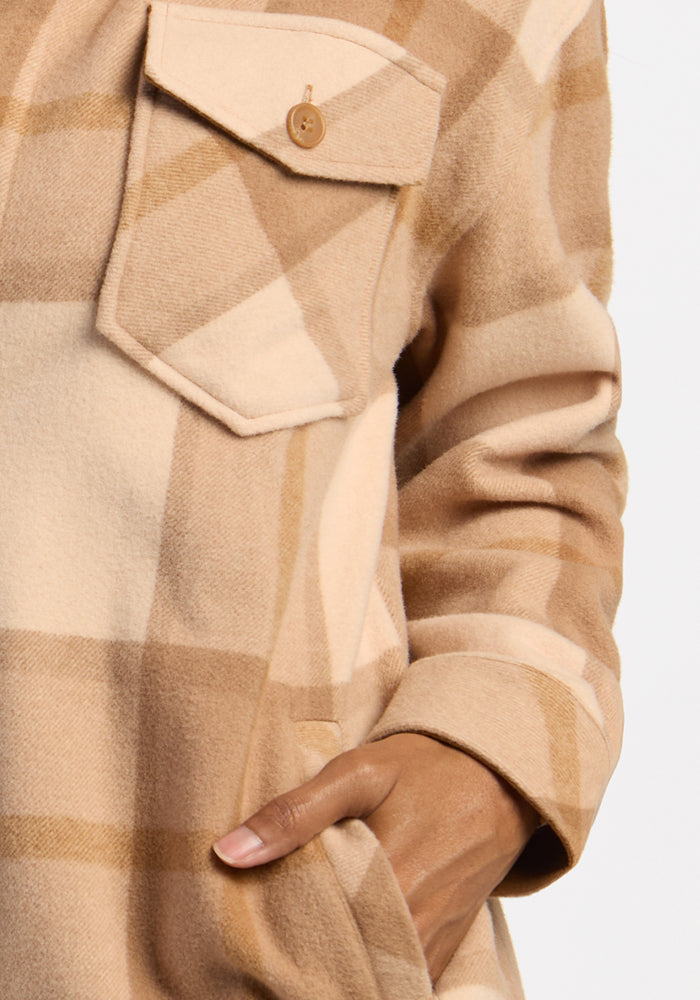 Someone wears the Woolx Sawyer Shacket in Saddleback Plaid, hand in pocket, chest pocket buttoned.