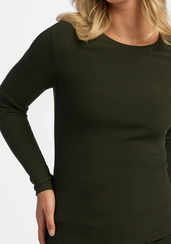 Model in Woolx Hadley Ribbed Crew - Duffel Bag, long sleeves, fitted, ribbed Merino wool, hand on hip.