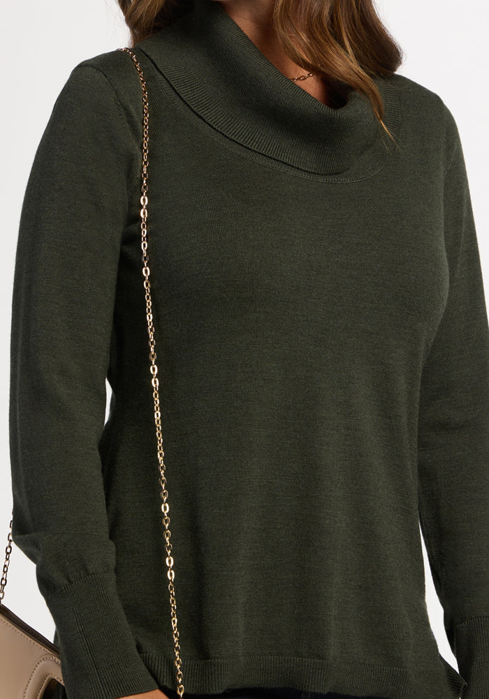 Woman in Woolx Josie Cowl Neck Sweater in Duffel Bag, carrying a tan purse with a gold chain strap.