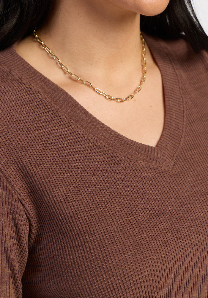 Woman wearing Woolx Evie Ribbed Tunic in Sable Heather and a gold chain necklace, shown from the shoulders up.