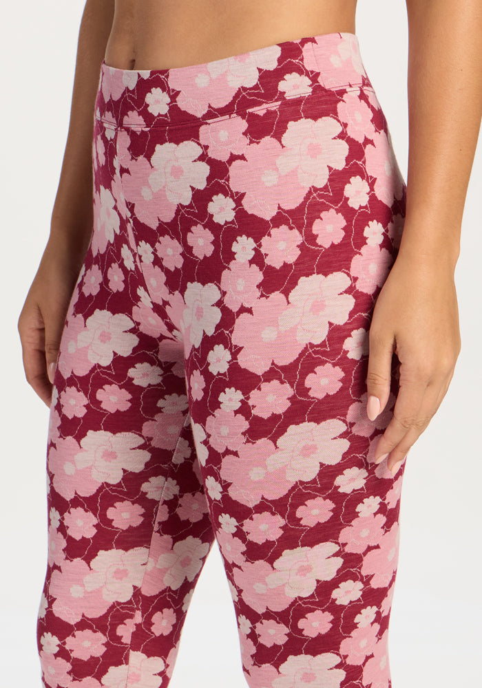 Model in Woolx Taylor Baselayer Leggings - Floral Crush, high-waisted, moisture-wicking, shown waist to thigh.