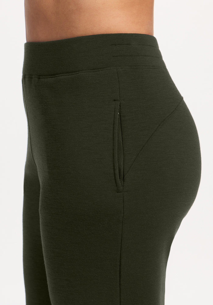 Side view of a person in Woolx Bree Lounge Pants - Duffel Bag, cozy straight-leg with a zippered pocket.