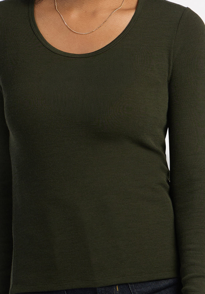 Model in Woolx Katie Ribbed Long Sleeve - Duffel Bag, styled with a thin gold necklace, shown neck to waist.