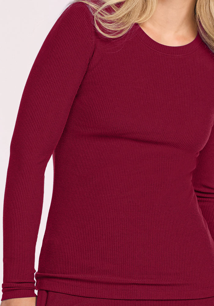Model wearing Woolx Hadley Petite Crew in Beet Red, shown shoulders to hips against a plain background.