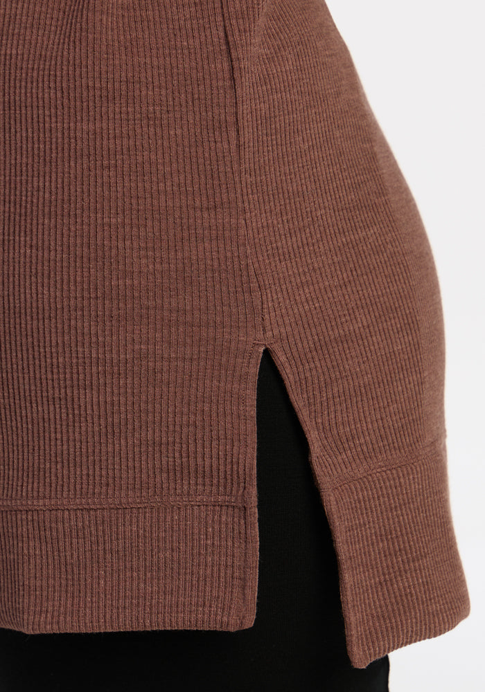 Close-up of the Woolx Evie Ribbed Tunic in Sable Heather, featuring a side slit, styled over black pants.