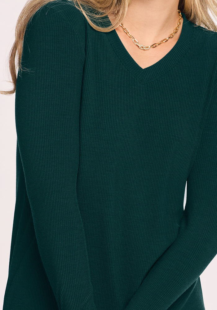 Person in Woolx Evie Ribbed Tunic - Deep Pine and a gold chain necklace, waist-up view.