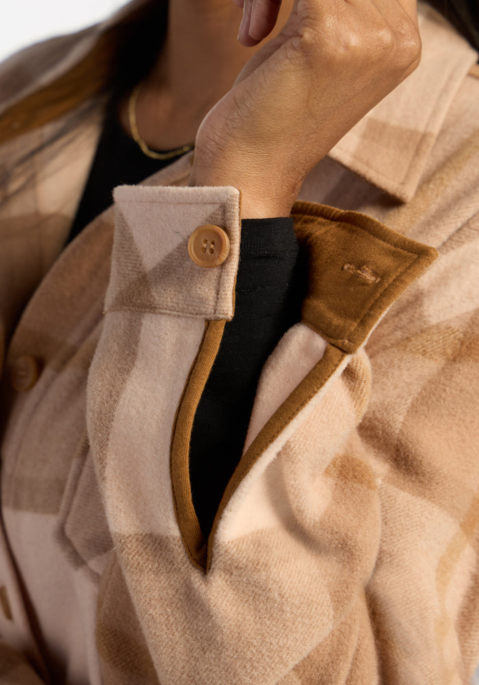 Someone wears the Woolx Sawyer Shacket in Saddleback Plaid, holding their hand near their face.