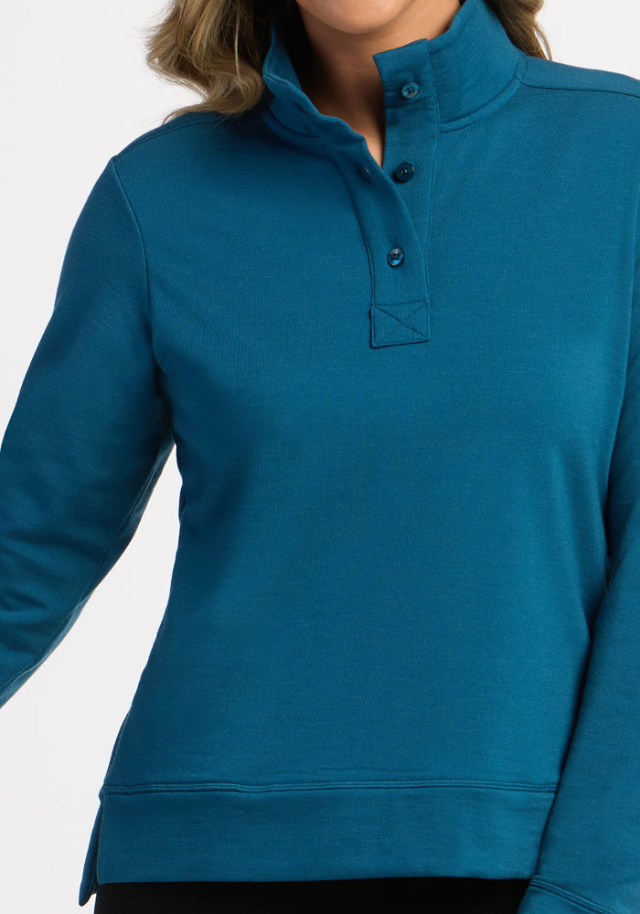 Model wearing Woolx Annie 3 Button Pullover in Blue Pine, shown from shoulders to hips.