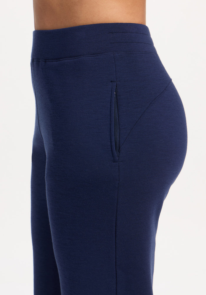 A side view of a person in Woolx Bree Lounge Pants - Ocean Cavern, featuring a zippered side pocket.
