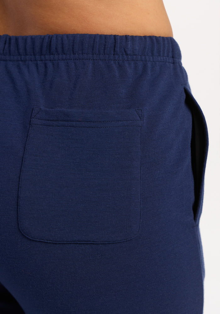 Close-up of a person wearing Woolx Juliette Joggers - Ocean Cavern with elastic waistband and back pocket.