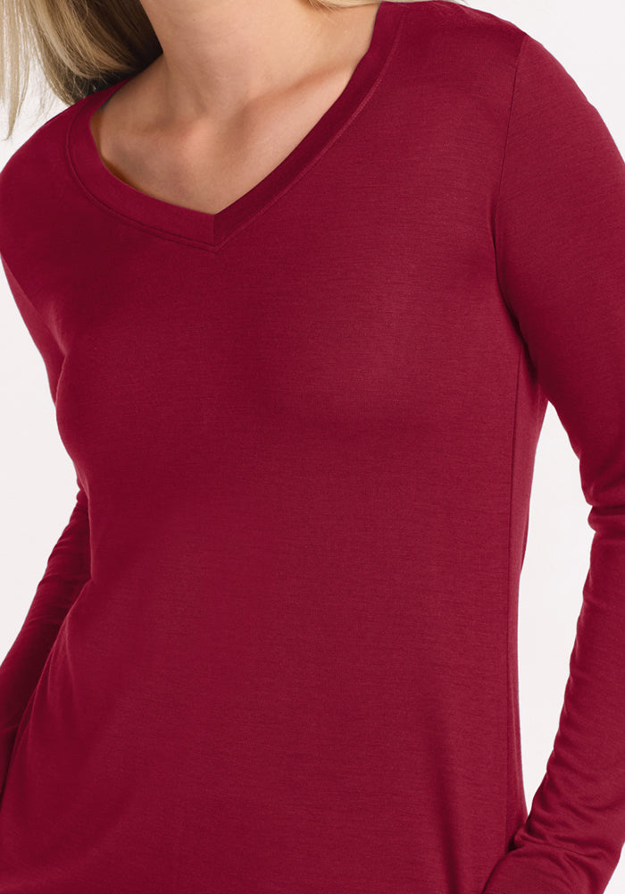 A woman wearing a beet red long-sleeve V-neck Lily V Neck Lounge Top.