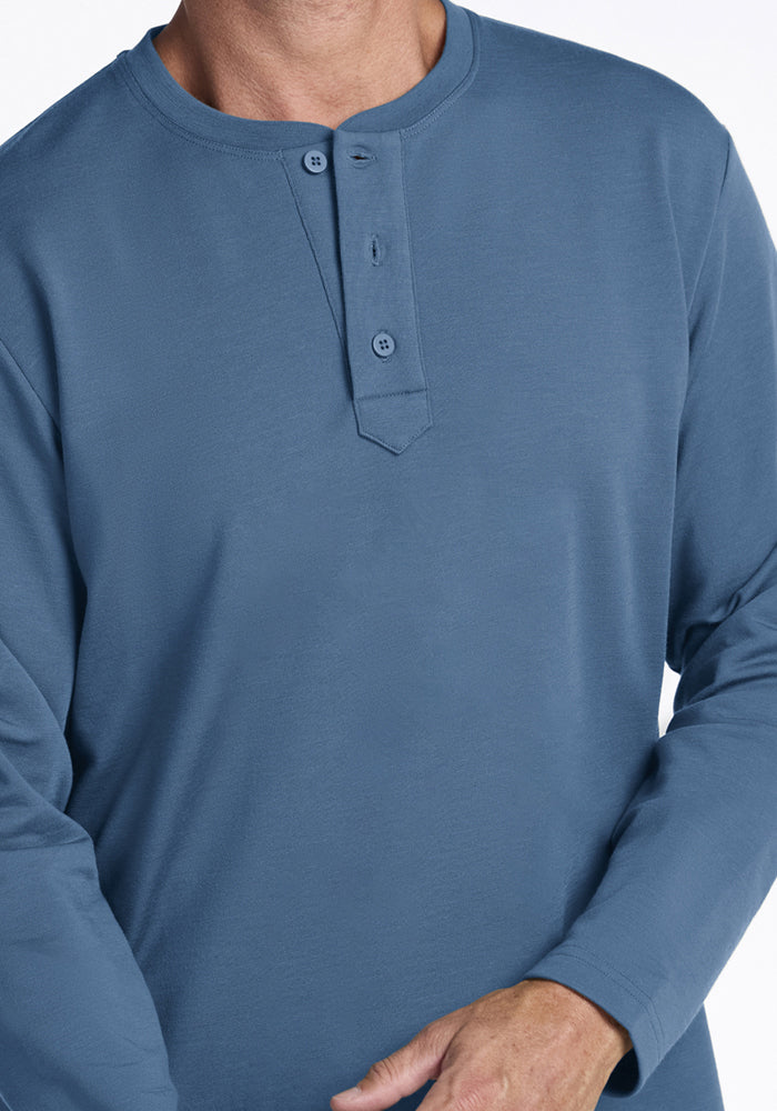 Person in a Woolx Jackson Henley - Blue Ashes, long sleeves, two collar buttons visible, hands partly shown.