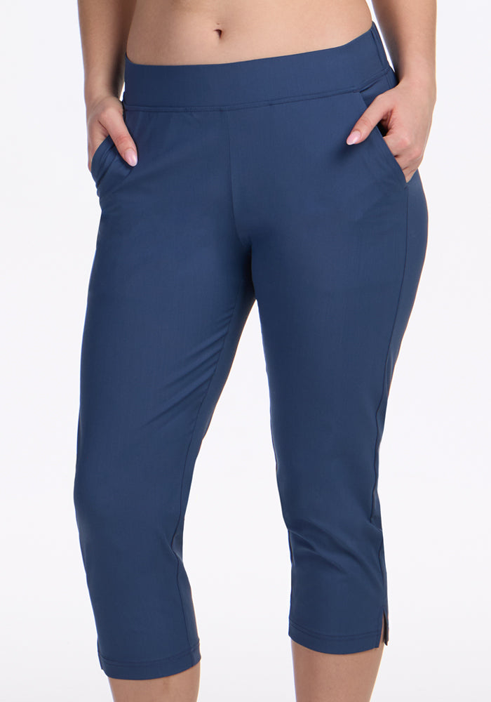 A person models the Woolx Nicole Crop Pants in Vintage Indigo, standing with hands in pockets, shown from waist to mid-calf against a plain white background.