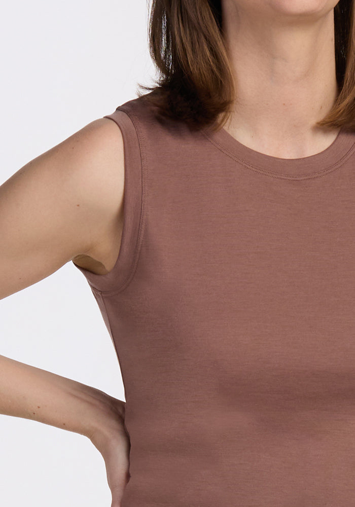 A woman wearing the Woolx Bella Tunic Top in Sienna Kiss stands with one hand on her hip, her head partially out of frame.
