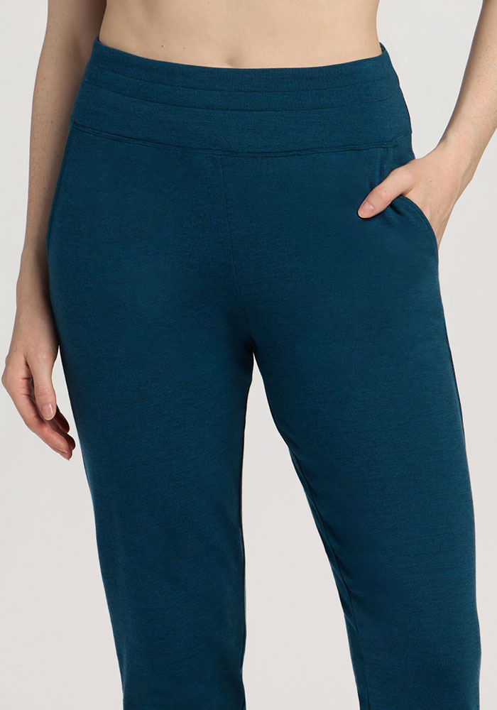 Person wearing Woolx Madden Joggers in Majolica Blue with one hand in the pocket, shown waist to mid-thigh.