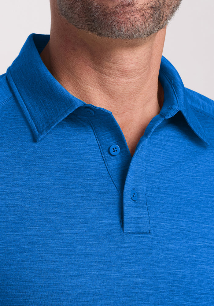 Close-up of a man wearing the Woolx Summit Polo in Glacial Blue, featuring two buttons fastened and a trimmed beard. This high-performance polo offers exceptional moisture management for all-day comfort.