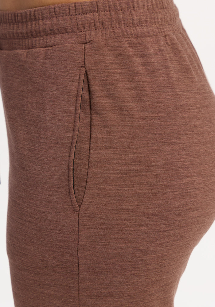 Close-up of a person in Woolx Eloise Wide Leg Pants - Sable Heather with an elastic, adjustable drawstring waistband.