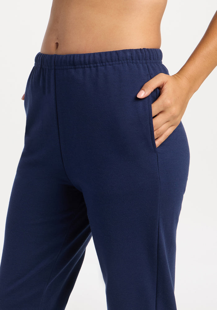 Model in Woolx Juliette Joggers - Ocean Cavern, hand in pocket, waist to mid-thigh view on white background.