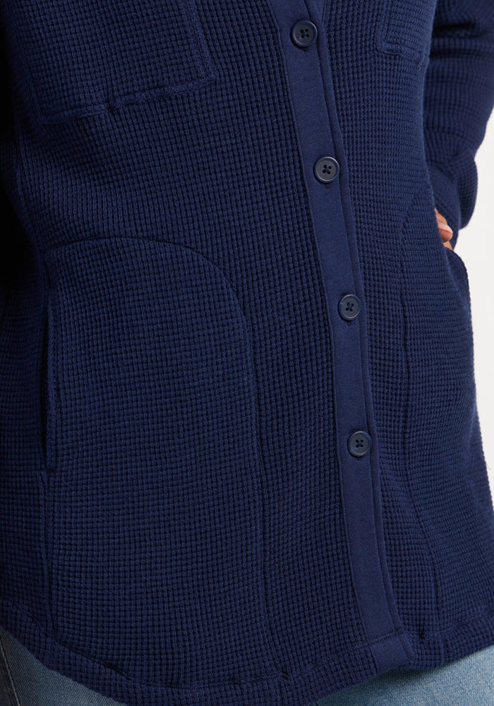 Close-up of the Woolx Oaklynn Waffle Shacket in Ocean Cavern, featuring pockets and buttons, perfect for layering.