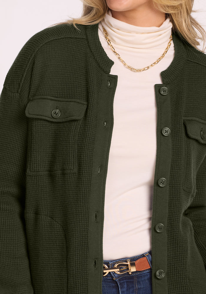 Woman in the Woolx Oaklynn Petite Waffle Shacket, white turtleneck, gold chain, and classic blue jeans.
