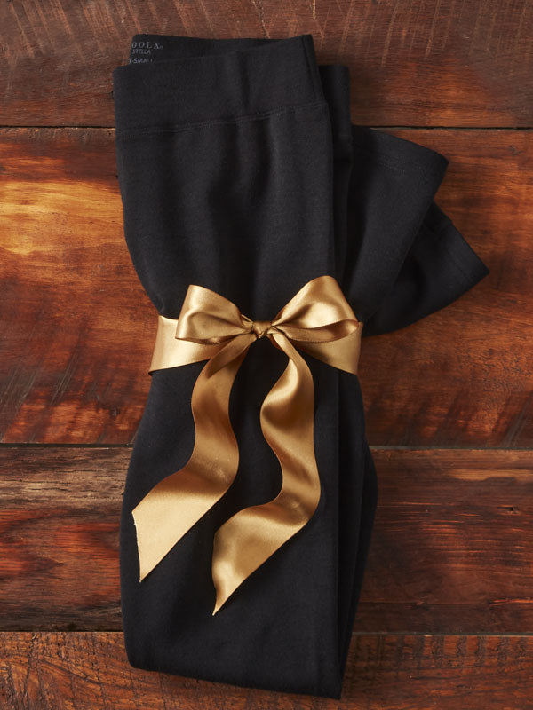 Black stella leggings wrapped in a gold bow